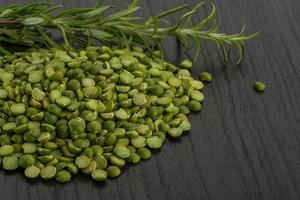 Dry green peas on wooden background photo