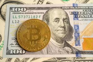Gold bitcoin on US dollar banknotes for electronic worldwide exchange virtual money, blockchain, cryptocurrency photo