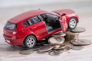 Car on stack of coins. Car loan, Finance, saving money, insurance and leasing time concepts. photo