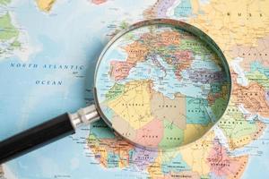 Bangkok, Thailand - May 01, 2022 Africa, Magnifying glass close up with colorful world map photo
