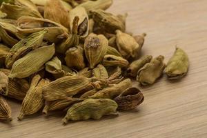 Cardamom on wooden background photo