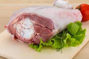 Turkey leg on wooden board and wooden background photo