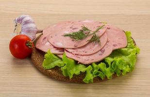 Beef sausage on wooden board and wooden background photo