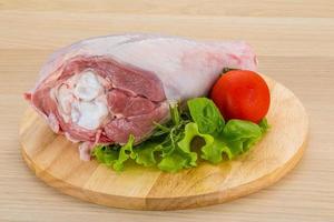 Turkey leg on wooden board and wooden background photo