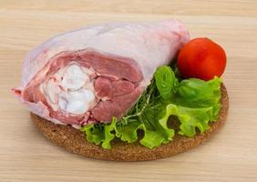 Turkey leg on wooden board and wooden background photo