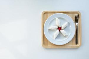 lazy dumplings on a plate, on a wooden tray with a fork. Light background photo