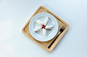 lazy dumplings on a plate, on a wooden tray with a fork. Light background photo
