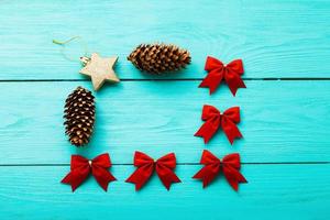 Frame of Christmas accessories on blue wooden background. Top view photo