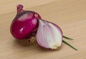 Red onion on wooden background photo