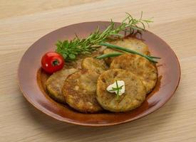 Hash brown on the plate and wooden background photo