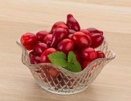 Cornus in a bowl on wooden background photo