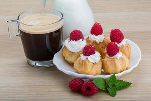 Profiterole with raspberry photo