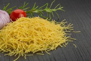 Vermicelli on wooden background photo