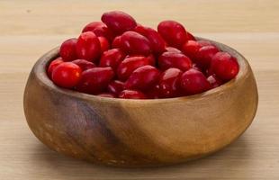 Cornus in a bowl on wooden background photo