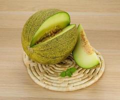 Melon on wooden board and wooden background photo