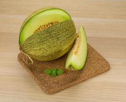 Melon on wooden board and wooden background photo