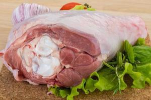 Turkey leg on wooden board and wooden background photo