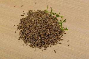 Caraway on wooden background photo