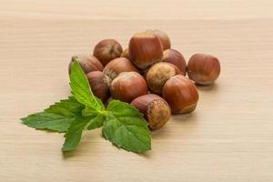 Hazelnut heap on wooden background photo