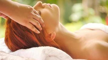 Beautiful caucasian woman getting head massage at spa. photo