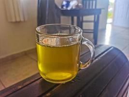 Glass or cup pot with hot ginger tea. photo