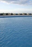 Ripples on the surface of an outdoor pool on a sunny day photo