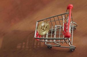 Shiny Bitcoin and a shopping cart photo