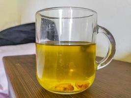 Glass or cup pot with hot ginger tea. photo