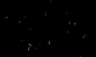 chispas ardientes al rojo vivo vuelan de un gran fuego en el cielo nocturno. hermoso fondo abstracto sobre el tema del fuego, la luz y la vida. foto