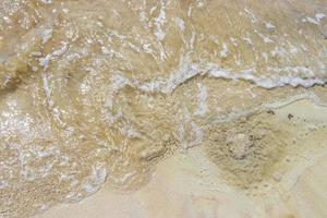 Small mini water waves at beach ocean with sand Mexico. photo