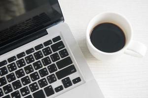 cup of coffee espresso with computer notebook photo