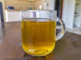 Glass or cup pot with hot ginger tea. photo