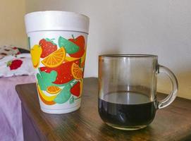 Glass cup of black coffee from Mexico on wooden background. photo