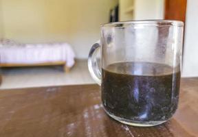 Glass cup of black coffee from Mexico on wooden background. photo