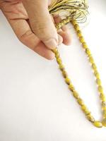 Round beads like marbles are often used for worship or after Muslim prayers, rosary beads isolated on white background. photo