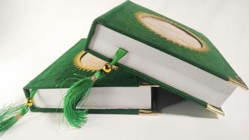 Yasin's book which is often read by Muslims after prayer. green cover isolated on a white background photo