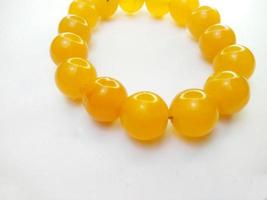 Marble jewelry bracelet. Yellow lucky bracelet isolated on a white background. Handmade beaded bracelet. Lifestyle.accessories.fashion.bracelets for men and women. photo