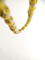 Round beads like marbles are often used for worship or after Muslim prayers, rosary beads isolated on white background. photo