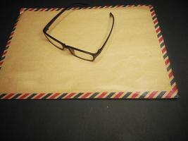 brown envelope and brown cover book on a black background photo