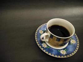 coffee cup floral pattern on black background photo