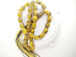 Round beads like marbles are often used for worship or after Muslim prayers, rosary beads isolated on white background. photo