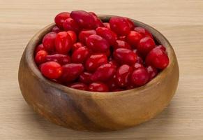 Cornus in a bowl on wooden background photo