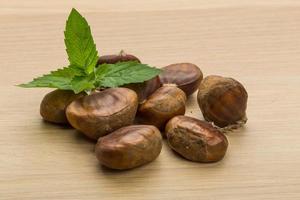 Chestnut on wooden background photo