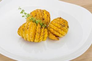 Baked potato on the plate photo