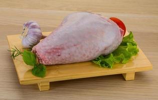 Turkey leg on wooden board and wooden background photo