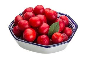 Damson plum in a bowl on white background photo