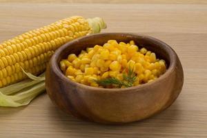 Sweet corn in a bowl on wooden background photo