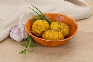 Baked potato in a bowl on wooden background photo