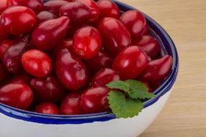 Cornus in a bowl on wooden background photo