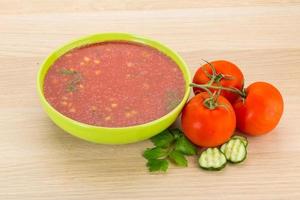 Gaspacho in a bowl on wooden background photo